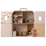 Miniature dollhouse with furniture and toy mice on a white background